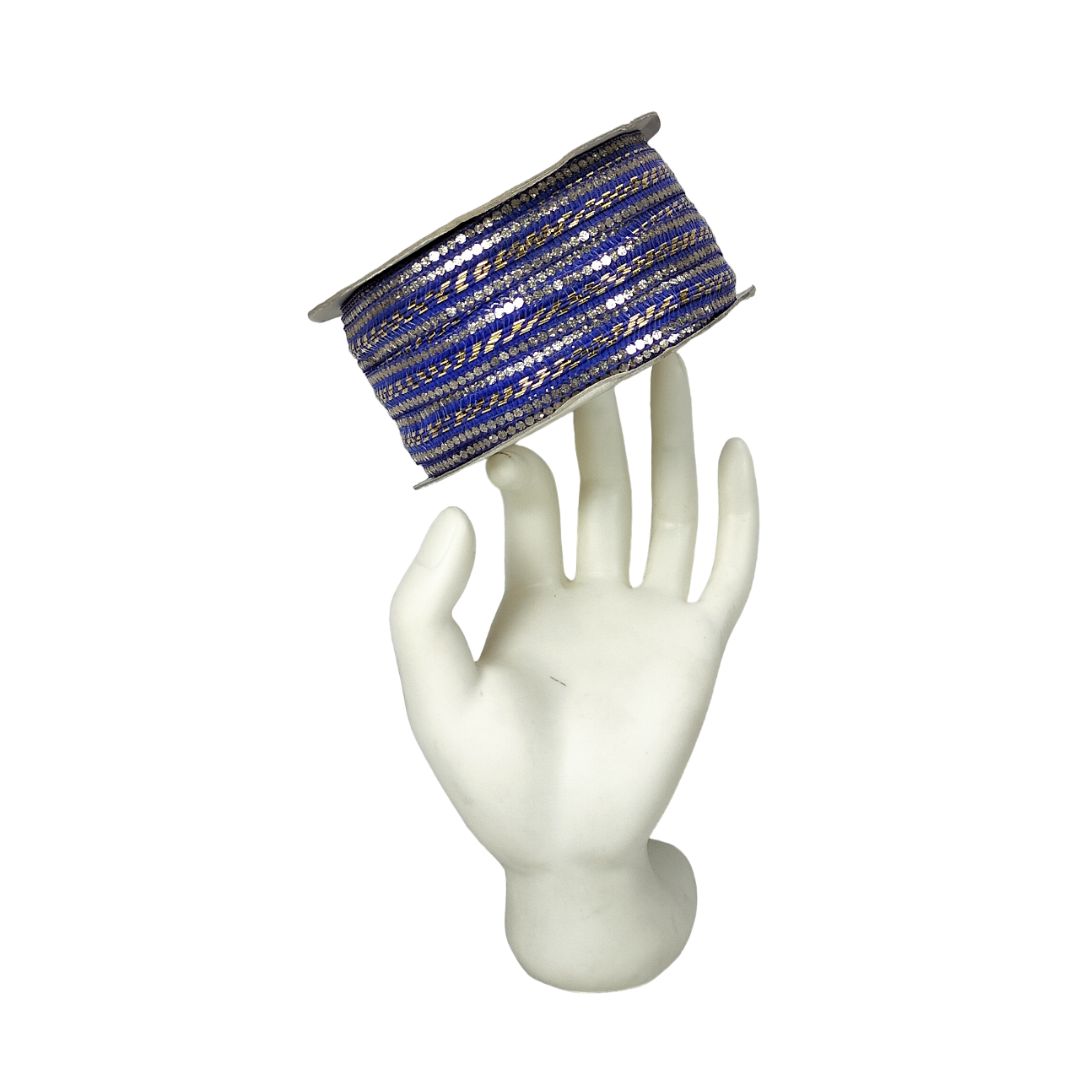 Blue and gold ribbon on a mannequin hand against a white background